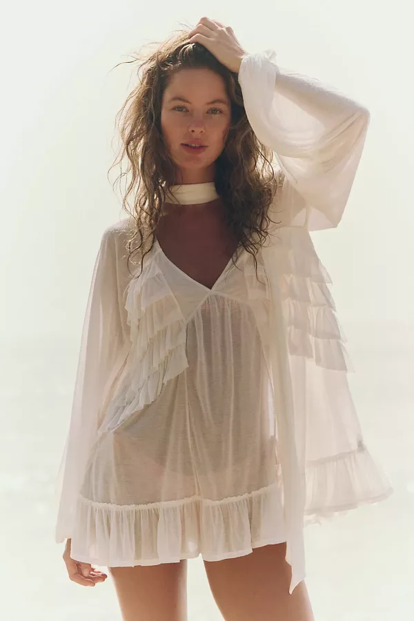 Model wearing a light flowy white tunic, perfect for sunny festivals