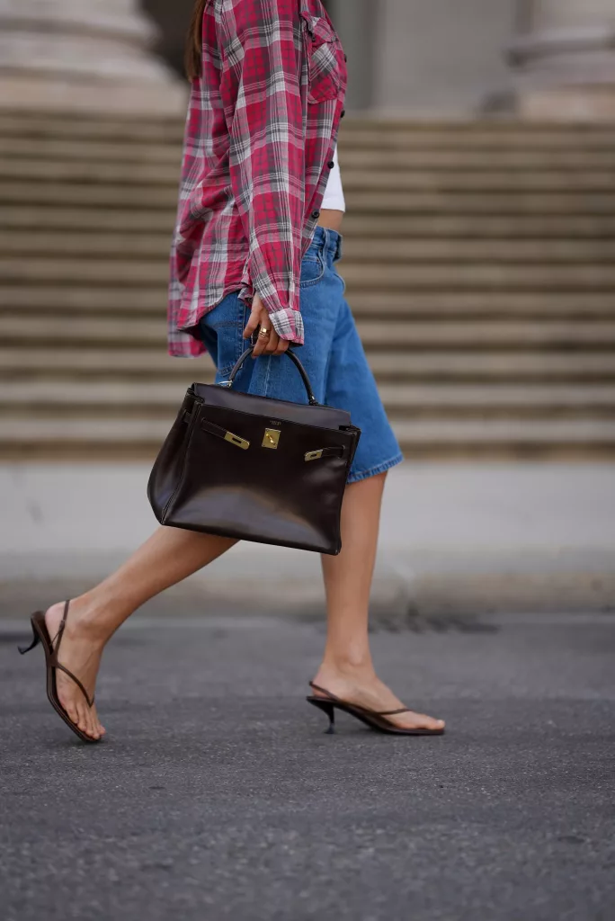 Woman wearing black micro kitten heels with a casual outfit
