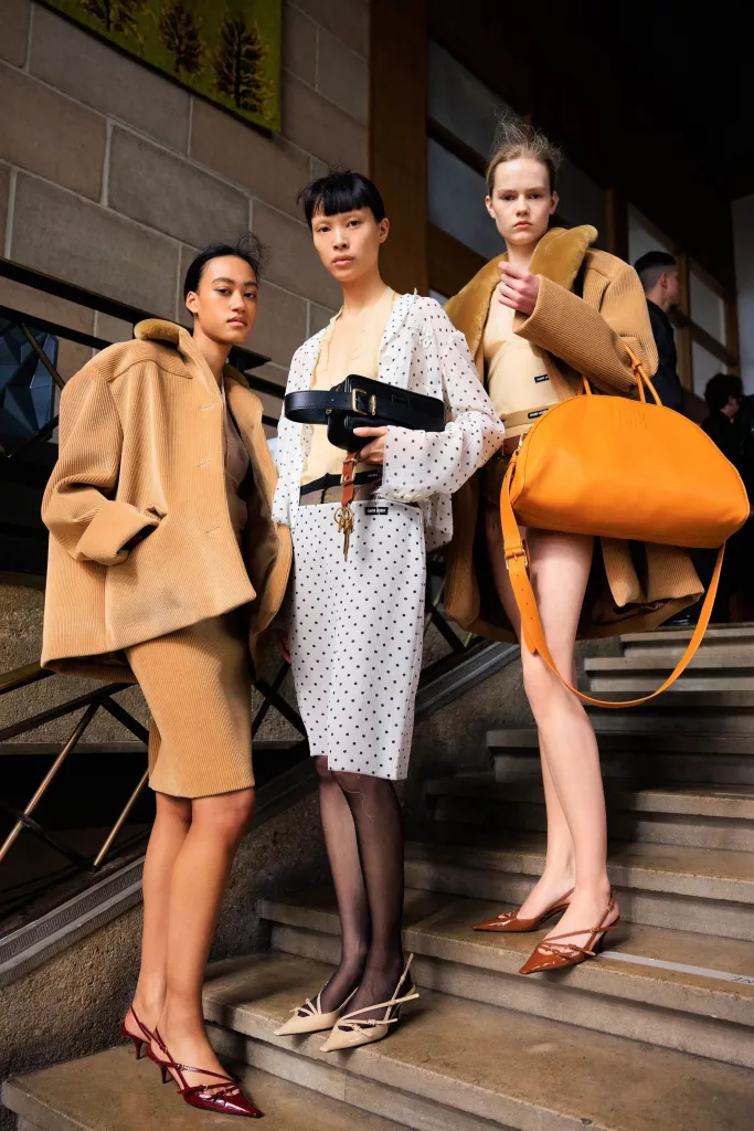 Models wearing micro kitten heels with contemporary outfits