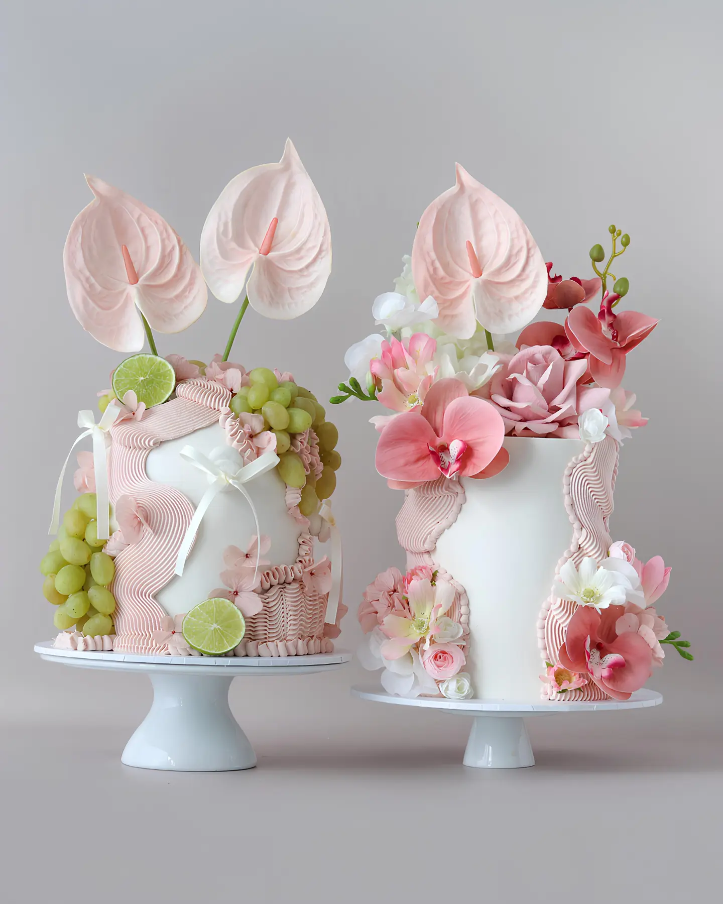 Domo cakes decorated with sculptural pink piping, flowers and fruit