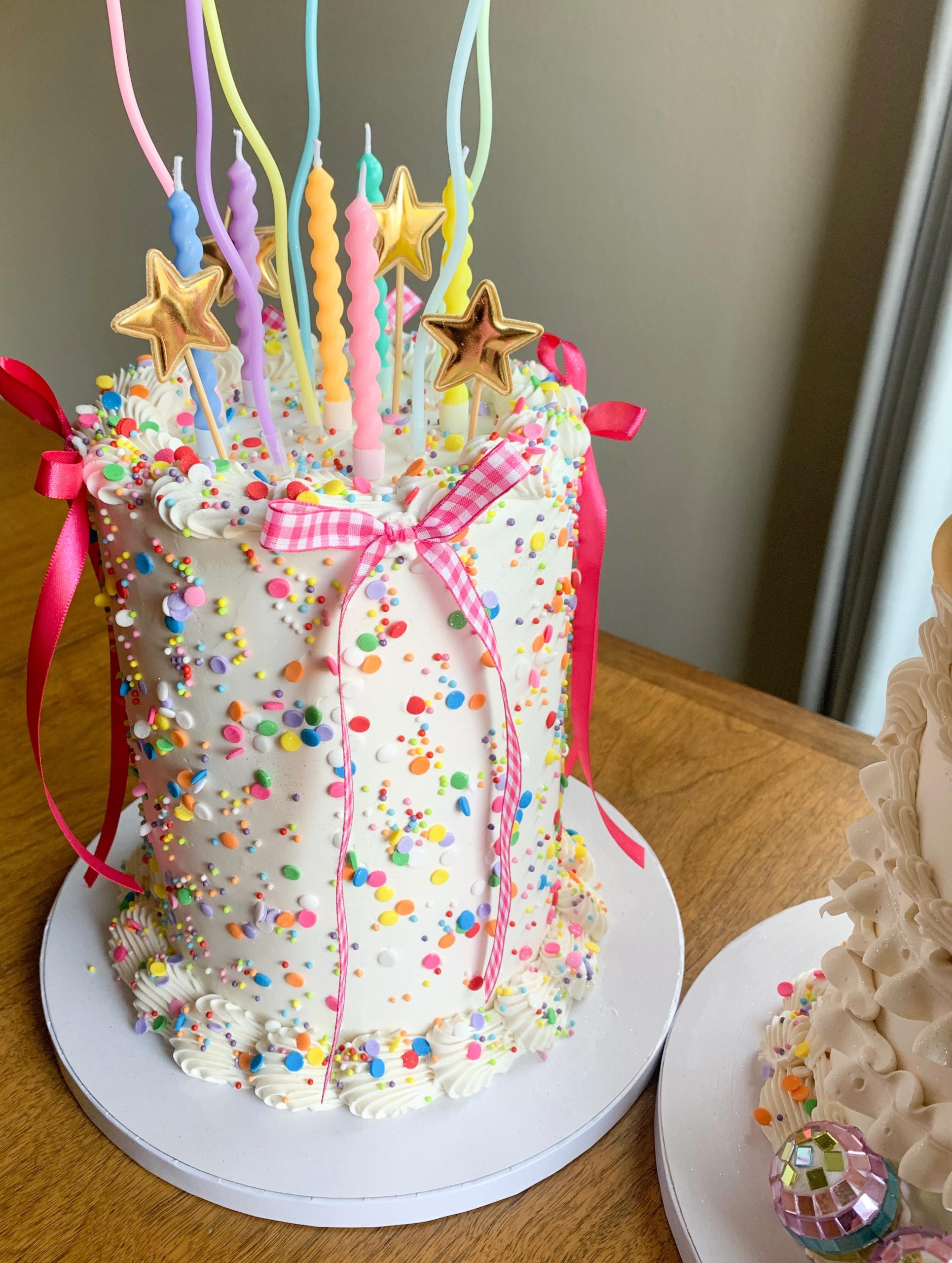 Confetti cake covered with colourful sprinkles and decorative details