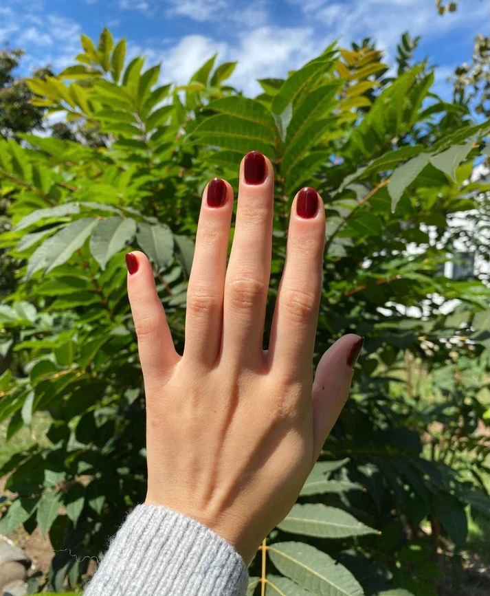 Glossy cherry red jammy nails with a sheer jelly finish