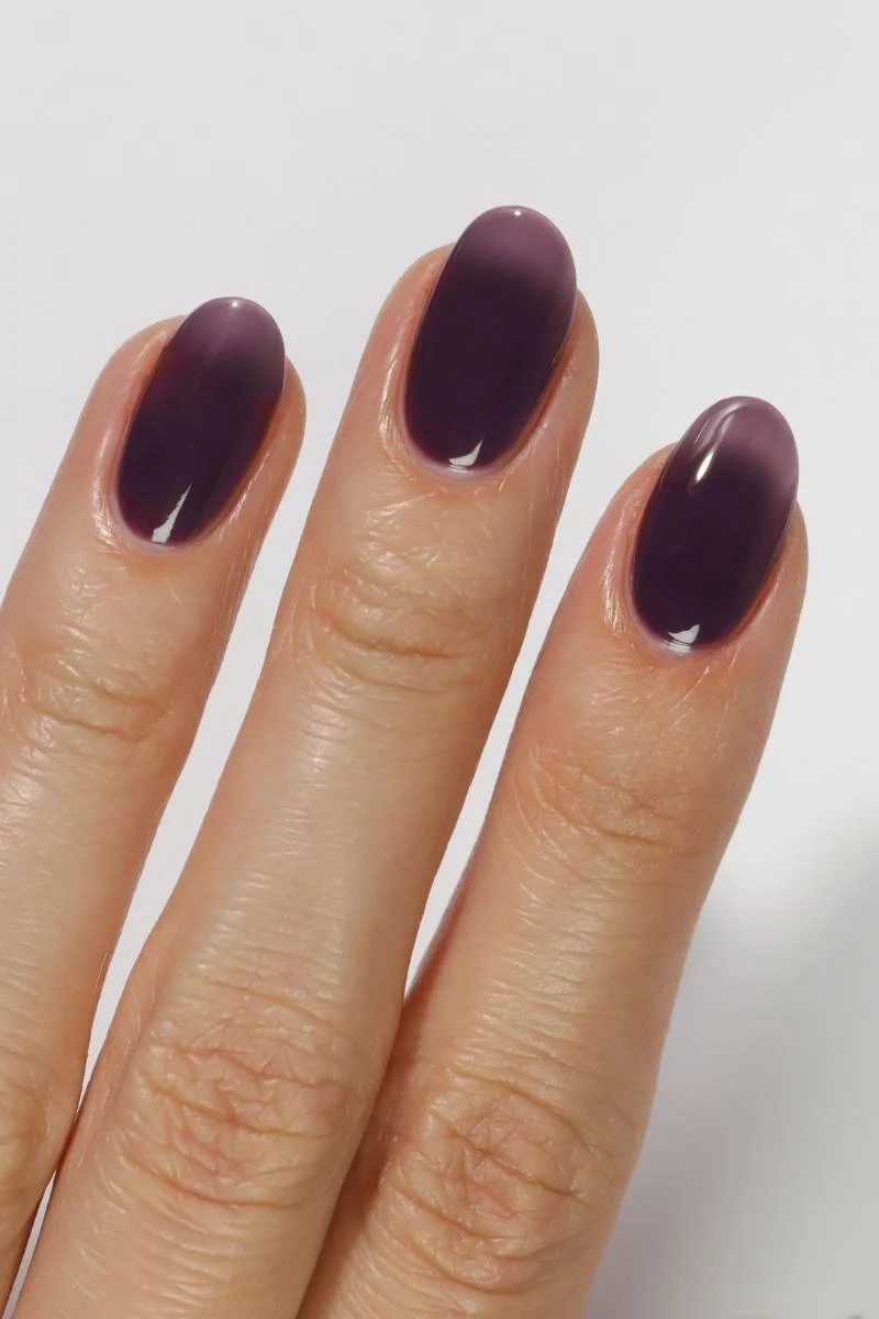 Deep fig purple jammy nails with a glossy translucent finish
