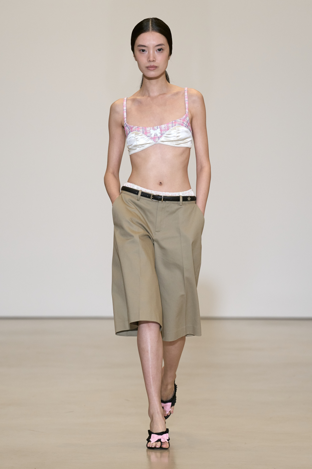 Sandy Liang Spring 2027 pale satin bra paired with loose knee-length shorts