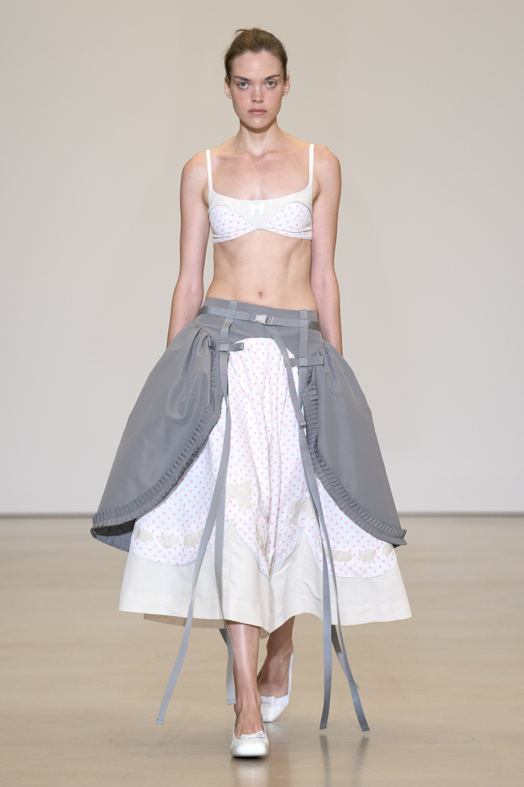 Sandy Liang Spring 2027 pale bra styled with a full skirt and grey panels