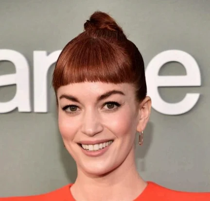 Jellyfish-inspired layered haircut with sharp bangs, worn by Britt Lower at the Grammys